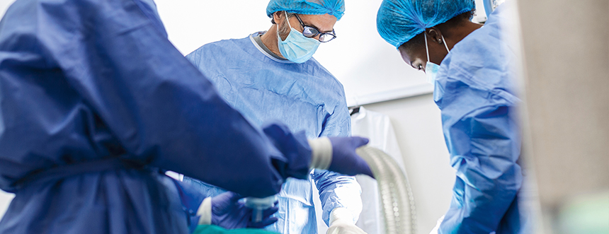 Image of surgeons performain a percutaneous dilation tracheostomy in the ICU.
